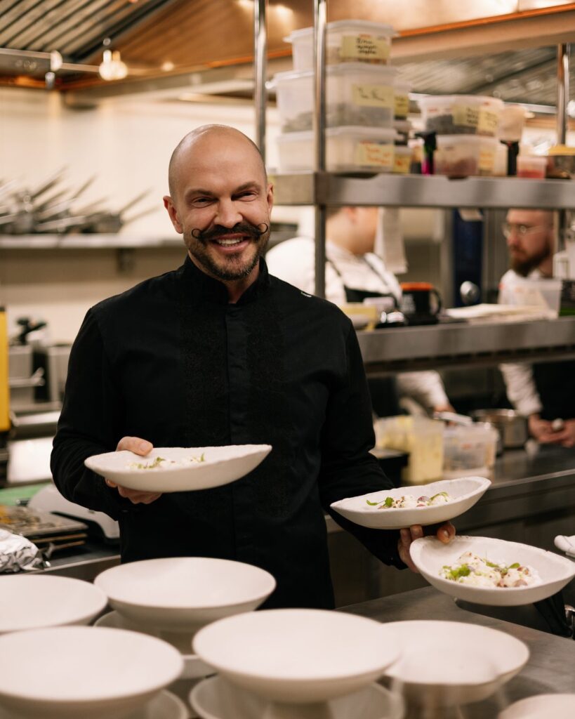Chef Volodymyr Yaroslavskyi com pratos acabados de empratar